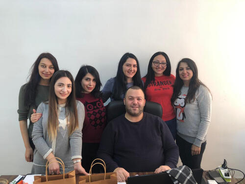 Elias Melky at his desk with ICS Yerevan staff